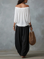 Mara | Ensemble composé d'un chemisier blanc à épaules dénudées et d'un pantalon palazzo noir