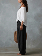 Mara | Ensemble composé d'un chemisier blanc à épaules dénudées et d'un pantalon palazzo noir